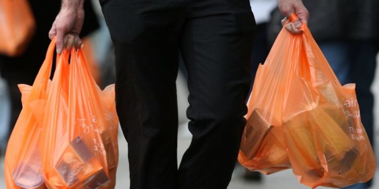 LONDON - FEBRUARY 29:  Shoppers leave a Sainsburys store with their purchases in plastic bags on February 29, 2008 in London, England. The Prime Minister Gordon Brown has stated that he will force retailers to help reduce the use of plastic bags if they do not do so voluntarily.  (Photo by Cate Gillon/Getty Images)