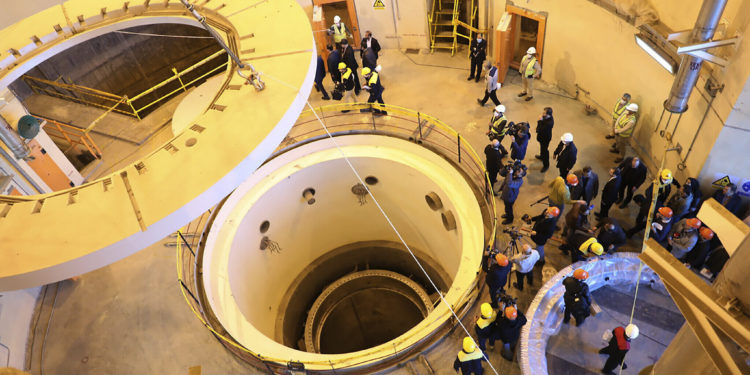 In this photo released by the Atomic Energy Organization of Iran, technicians work at the Arak heavy water reactor's secondary circuit, as officials and media visit the site, near Arak, 150 miles (250 kilometers) southwest of the capital Tehran, Iran, Monday, Dec. 23, 2019. The head of Iran's nuclear agency says his country has begun new operations at the  heavy water nuclear reactor. The move intensifies pressure on Europe to find an effective way around U.S. sanctions, which block Tehran's oil sales abroad. (Atomic Energy Organization of Iran via AP)