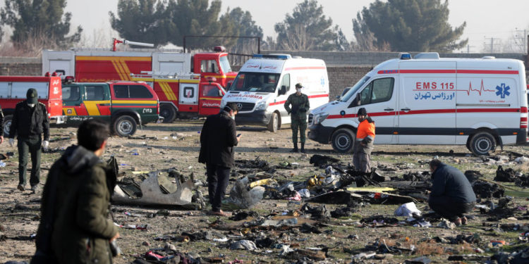 Rescue teams work amidst debris after a Ukrainian plane carrying 176 passengers crashed near Imam Khomeini airport in the Iranian capital Tehran early in the morning on January 8, 2020, killing everyone on board. - The Boeing 737 had left Tehran's international airport bound for Kiev, semi-official news agency ISNA said, adding that 10 ambulances were sent to the crash site. (Photo by - / AFP) (Photo by -/AFP via Getty Images)