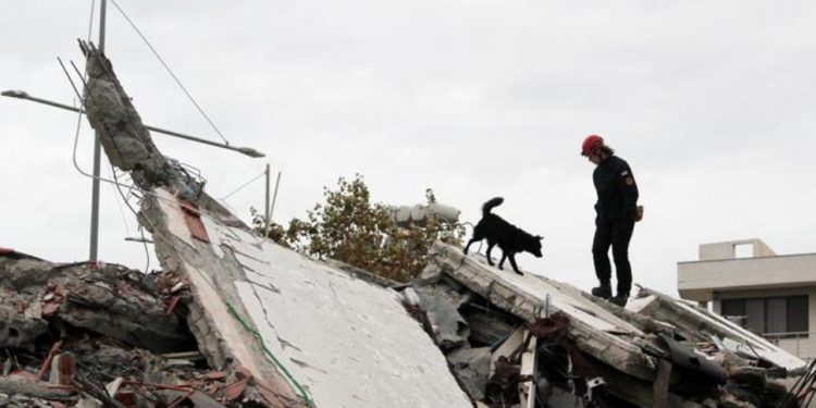 epa08031103 A Search and rescue team member from Croatia searches in the rubble of a building after an earthquake hit Durres, Albania, 28 November 2019. Albania was hit by a 6.4 magnitude earthquake on 26 November 2019, leaving at least 41 people dead and dozens injured.  EPA/MALTON DIBRA