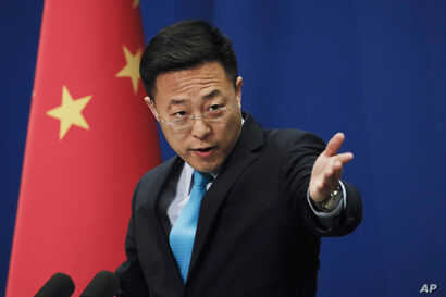 Chinese Foreign Ministry new spokesman Zhao Lijian gestures as he speaks during a daily briefing at the Ministry of Foreign Affairs office in Beijing, Monday, Feb. 24, 2020. China's foreign ministry on Monday said it didn't matter that three expelled journalists had nothing to do with a Wall Street Journal editorial that Beijing deemed racist, and called on the paper to apologize. (AP Photo/Andy Wong)