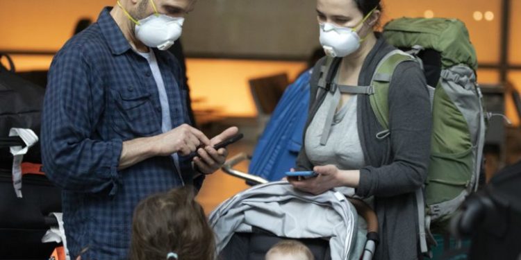 People arriving on a flight from Europe at Logan International Airport in Boston, ahead of a travel ban, on Friday, March, 13, 2020.