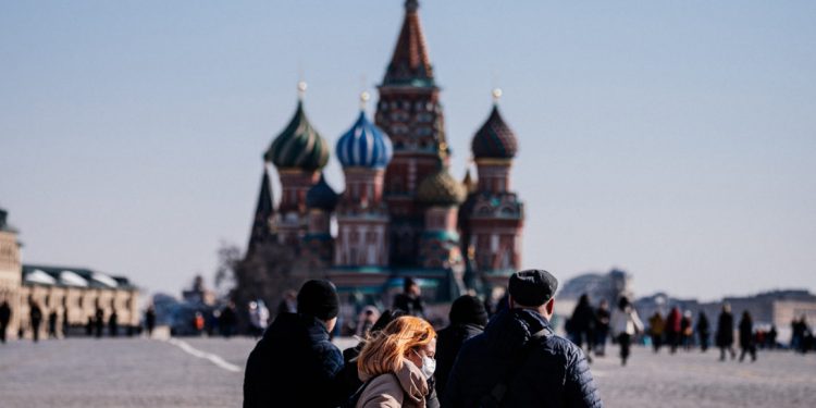 A woman wearing a protective face mask due to fears of the coronavirus disease (COVID-19) walks on Red Square in front of St.Basil's Cathedral in downtown Moscow on March 17, 2020. (Photo by Dimitar DILKOFF / AFP) (Photo by DIMITAR DILKOFF/AFP via Getty Images)