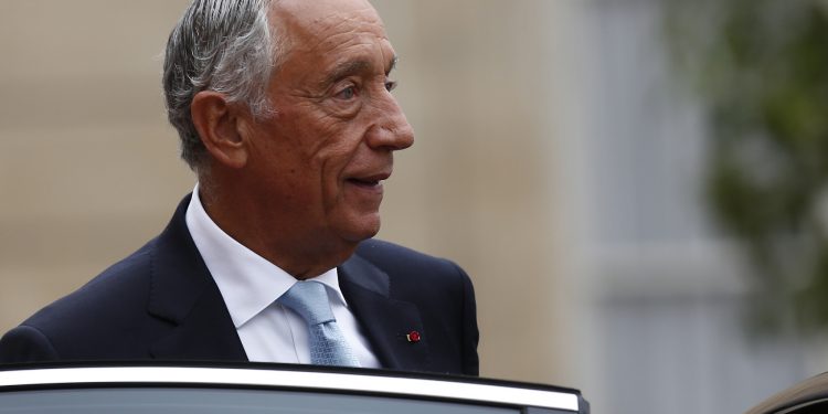 FILE - In this Sunday, July 14, 2019 file photo, Portugal's President Marcelo Rebelo de Sousa leaves after a lunch at the Elysee Palace that followed Bastille Day parade on the Champs-Elysees avenue in Paris. The office of Portugal's 71-year-old president said Sunday March 8, 2020 that he has canceled all public activities and will stay at home amid the coronavirus outbreak. (AP Photo/Kamil Zihnioglu, File)