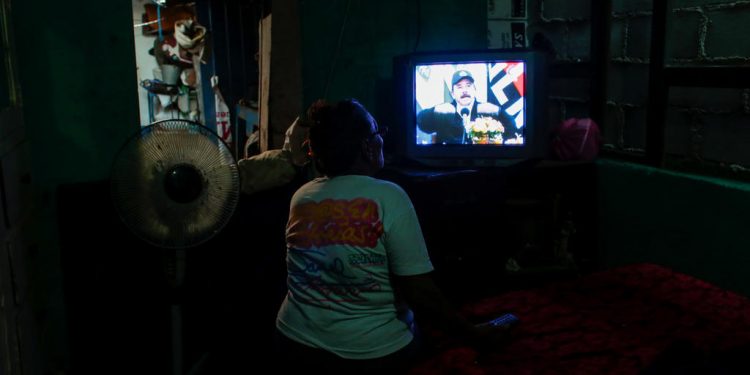 A supporter watches a telecast of Nicaraguan President Daniel Ortega addressing the nation in Managua, Nicaragua, April 15, 2020.REUTERS/Oswaldo Rivas