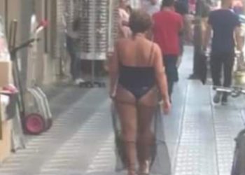 Vajza tek “Tregu Çam” del me rroba banjo në mes të qytetit