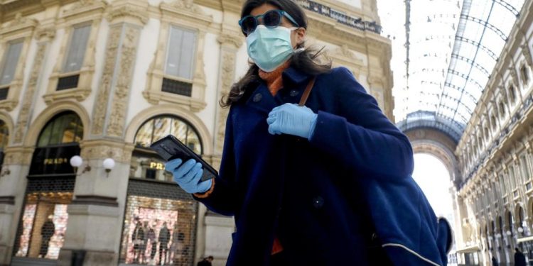 Mandatory Credit: Photo by MOURAD BALTI TOUATI/EPA-EFE/Shutterstock (10579897e)
A woman wearing a face mask walks past  the deserted Galleria Vittorio Emanuele II amid coronavirus outbreak, in Milan, Italy, 11 March 2020.
Coronavirus in Italy, Milan - 11 Mar 2020