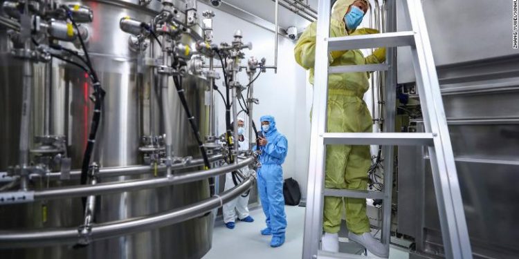 HOLD FOR STORY VIRUS OUTBREAK SELF EXPERIMENTATION In this April 11, 2020 photo released by Xinhua News Agency, staff members check and clean equipments at a vaccine production plant of China National Pharmaceutical Group (Sinopharm) in Beijing. In the global race to make a coronavirus vaccine, the state-owned Chinese company is boasting that it gave its employees, including top executives, experimental shots even before the government OK'd testing in people.   (Zhang Yuwei/Xinhua via AP)