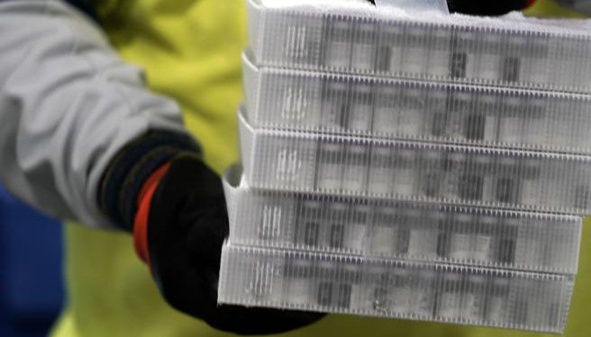 Boxes containing the Pfizer-BioNTech COVID-19 vaccine are prepared to be shipped at the Pfizer Global Supply Kalamazoo manufacturing plant in Portage, Mich., Sunday, Dec. 13, 2020. (AP Photo/Morry Gash, Pool)