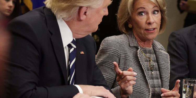 WASHINGTON, DC - FEBRUARY 14:  U.S. Secretary of Education Betsy DeVos (R) speaks as President Donald Trump (L)  listens during a parent-teacher conference listening session at the Roosevelt Room of the White House February 14, 2017 in Washington, DC. The White House held the session to discuss education.  (Photo by Alex Wong/Getty Images)