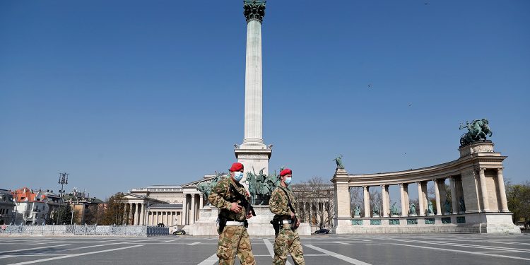 Military police officers patrol the deserted Heroes' Square as the spread of coronavirus disease (COVID-19) continues in Budapest, Hungary, April 6, 2020. REUTERS/Bernadett Szabo