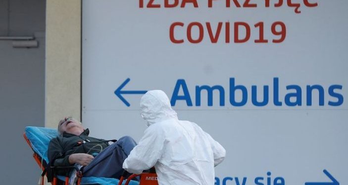 FILE PHOTO: A paramedic transports a COVID-19 patient at a hospital in Warsaw, Poland December 3, 2020. REUTERS/Kacper Pempel