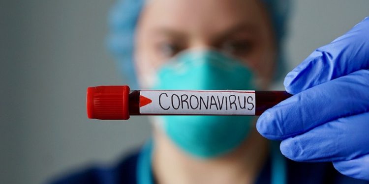 Nurse wearing respirator mask holding a positive blood test result for the new rapidly spreading Coronavirus, originating in Wuhan, China