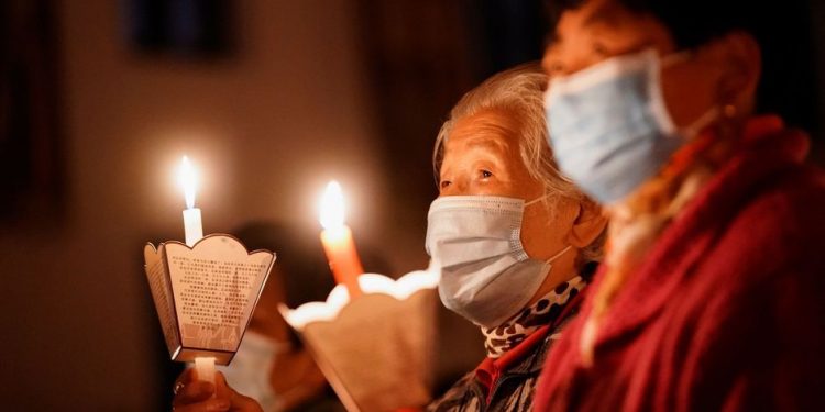 People attend an Easter Vigil service, amid the coronavirus disease (COVID-19) outbreak, at a Catholic church in Shanghai, China April 3, 2021. REUTERS/Aly Song