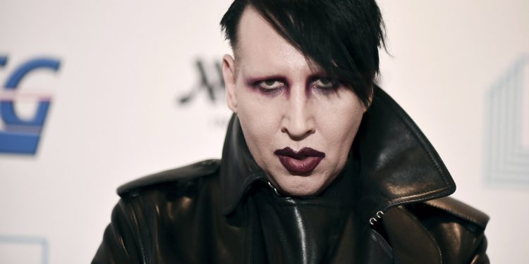 FILE - Marilyn Manson attends the 9th annual "Home for the Holidays" benefit concert on Dec. 10, 2019, in Los Angeles. Manson was dropped by his record label Monday after his ex-fiancé, the actor Evan Rachel Wood, accused him of sexual and other physical abuse. (Photo by Richard Shotwell/Invision/AP, File)