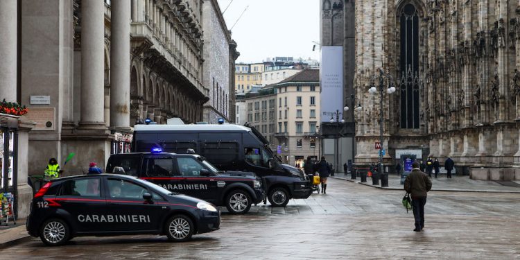Police check in Piazza Duomo during Christmas Eve in Milan on December 24, 2020, Italy. The Italian government has decreed a total red zone for the Christmas holidays to reduce Coronavirus infection. Bars, restaurants and unnecessary activities will remain closed until January 6, 2021. (Photo by Mairo Cinquetti/NurPhoto via Getty Images)