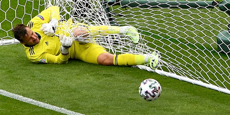 Scotland's goalkeeper David Marshall is caught in the goal's net after he failed to safe a long distance shot by Czech Republic's Patrik Schick during the Euro 2020 soccer championship group D match between Scotland and Czech Republic at Hampden Park stadium in Glasgow, Monday, June 14, 2021. (AP Photo/Andy Buchanan, Pool) ORG XMIT: SOB130