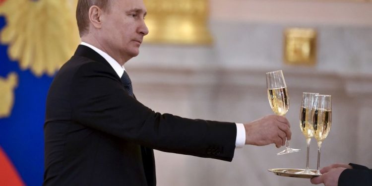 FILE PHOTO: Russia's President Vladimir Putin holds a glass as he attends a ceremony to receive credentials from foreign ambassadors at the Kremlin in Moscow, Russia, April 20, 2016. REUTERS/Kirill Kudryavtsev/Pool/File Photo