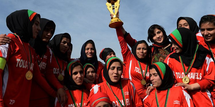Afghan female football players from Afghan team celebrate with the trophy after their women's football tournament final match against Isteghlal in Kabul on December 6, 2013. Afghan defeated Isteghlal to win the tournament. The month-long women's football tournament, which saw some 16 teams participate, was held to select top players for the Afghan national women's football team. AFP PHOTO/Aref  KARIMI        (Photo credit should read Aref Karimi/AFP/Getty Images)