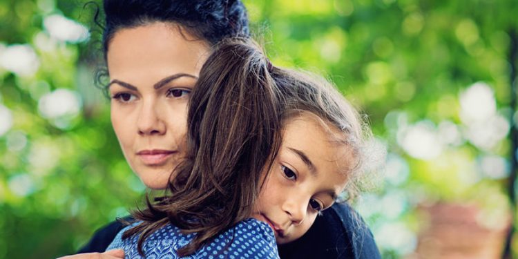 Mother is holding her beloved daughter.