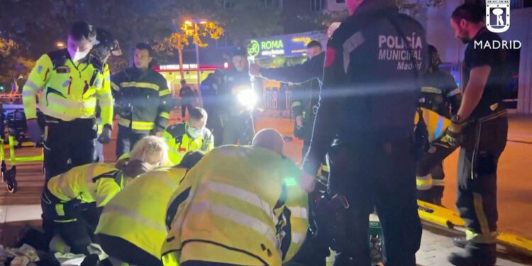 Rescuers work outside a restaurant following a fire, in Madrid, Spain, April 21, 2023, in this screen grab taken from a handout video. Madrid Emergency Service/Handout via REUTERS