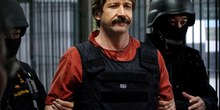 FILE PHOTO: Suspected Russian arms dealer Viktor Bout is escorted by members of a special police unit after a hearing at a criminal court in Bangkok October 5, 2010. REUTERS/Sukree Sukplang/File Photo