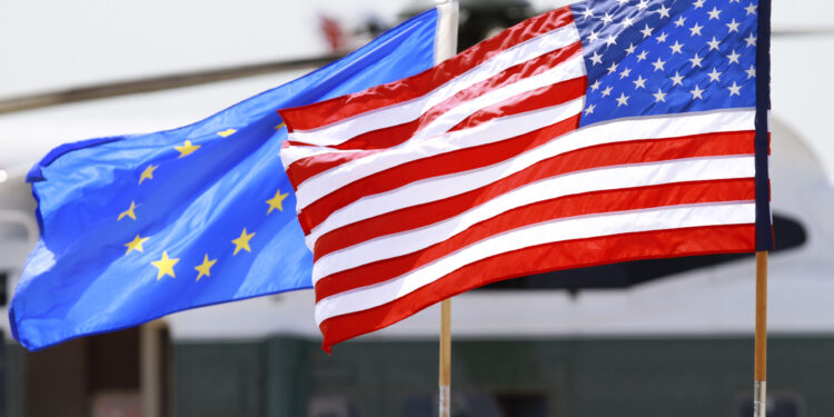 The U.S. and European Union flags wave as members of the EU Delegation arrive to attend the G8 Summit, Friday, May 18, 2012, at Dulles International Airport in Chantilly, Va. (AP Photo/Jacquelyn Martin)