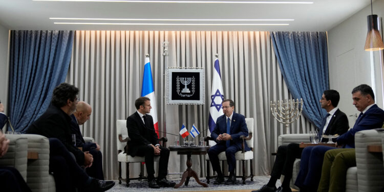 French President Emmanuel Macron, left, meets Israel's President Isaac Herzog in Jerusalem, Tuesday, Oct. 24, 2023. Emmanuel Macron is traveling to Israel to show France's solidarity with the country and further work on the release of hostages who are being held in Gaza.      Christophe Ena/Pool via REUTERS