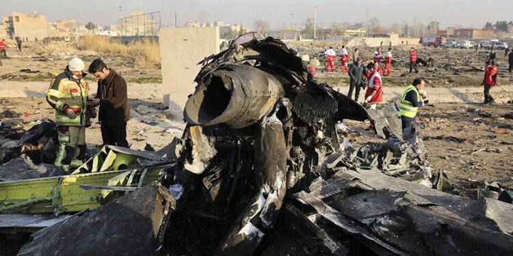 FILE - In this Jan. 8, 2020, file photo, debris at the scene where a Ukrainian plane crashed in Shahedshahr southwest of the capital Tehran, Iran. Iranian media are quoting the outgoing military prosecutor of Tehran as saying that 10 officials have been indicted for the 2020 shootdown of a Ukrainian passenger plane. (AP Photo/Ebrahim Noroozi, File)