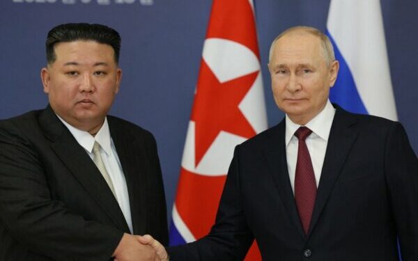 TOPSHOT - This pool image distributed by Sputnik agency shows Russian President Vladimir Putin (R) and North Korea's leader Kim Jong Un (L) shaking hands during their meeting at the Vostochny Cosmodrome in Amur region on September 13, 2023, ahead of planned talks that could lead to a weapons deal with Russian President. (Photo by Vladimir SMIRNOV / POOL / AFP) (Photo by VLADIMIR SMIRNOV/POOL/AFP via Getty Images)