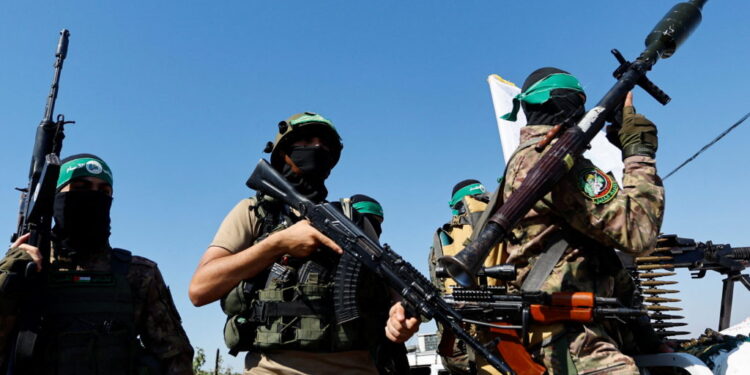 Palestinian fighters from the armed wing of Hamas take part in a military parade to mark the anniversary of the 2014 war with Israel, near the border in the central Gaza Strip, July 19, 2023. REUTERS/Ibraheem Abu Mustafa