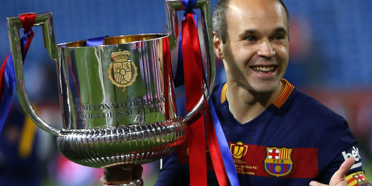 Barcelona's Andres Iniesta carries the trophy after winning the final of the Copa del Rey soccer match between FC Barcelona and Sevilla FC at the Vicente Calderon stadium in Madrid, Sunday, May 22, 2016. Barcelona won 2-0 (AP Photo/Francisco Seco)