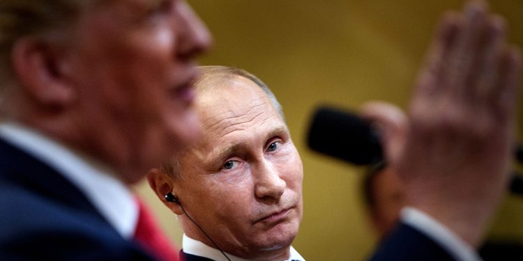 Russia's President Vladimir Putin listens while US President Donald Trump speaks during a press conference at Finland's Presidential Palace July 16, 2018 in Helsinki, Finland. - The US and Russian leaders opened an historic summit in Helsinki, with Donald Trump promising an "extraordinary relationship" and Vladimir Putin saying it was high time to thrash out disputes around the world. (Photo by Brendan Smialowski / AFP)        (Photo credit should read BRENDAN SMIALOWSKI/AFP/Getty Images)