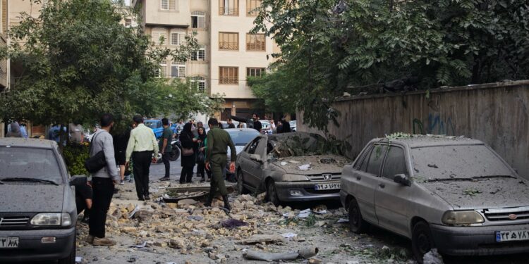 TEHRAN, IRAN - JUNE 13: People look over damage to buildings following Israeli airstrikes on June 13, 2025 in Tehran, Iran. Iran's three top military generals were killed in the attacks that also targeted nuclear and military facilities, according to published reports. Israel described the strikes as preemptive to keep Iran from obtaining nuclear weapons, the reports said.  (Photo by Majid Saeedi/Getty Images)