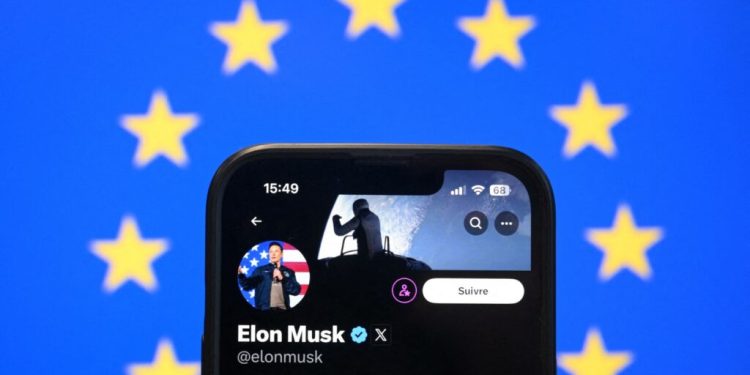 This illustration photograph shows Elon Musk's X (formerly Twitter) account displayed on a smartphone in front a European Union flag in Brussels on January 7, 2025. European leaders have expressed growing frustration with the US tech billionaire Musk, a key ally to the US President-elect Donald Trump, amid his increasingly strident interventions into their domestic politics. (Photo by Nicolas TUCAT / AFP)