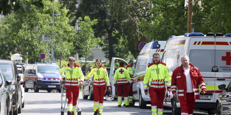 Rescue service personnel attend the scene of a shooting at a school in Graz, Austria, Tuesday, June 10, 2025. (Kleine Zeitung via AP)